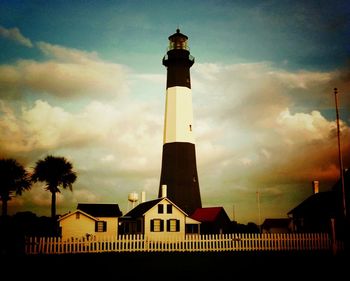 Low angle view of lighthouse against cloudy sky