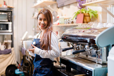 Portrait of smiling young barista