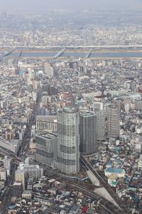 High angle view of modern buildings in city against sky