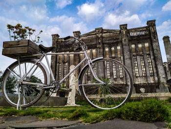 Bicycle against building in city