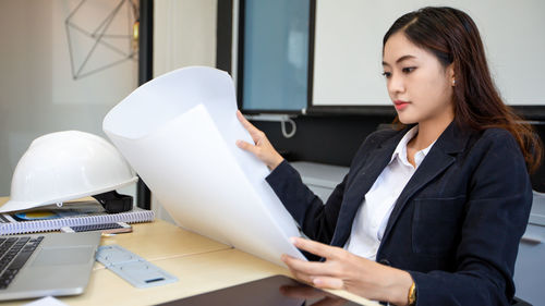 Portrait of young businesswoman working on table