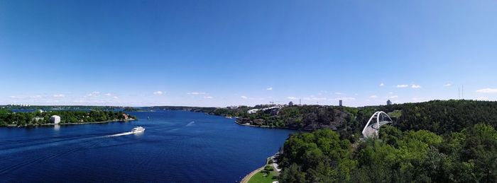 Panoramic view of bridge over river against blue sky