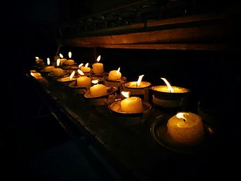 Lit tea light candles in temple