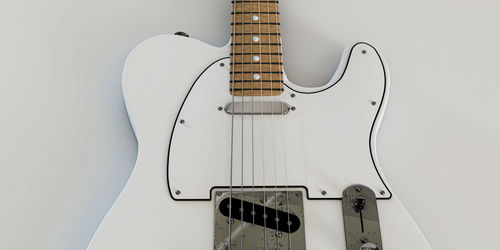 Close-up of guitar against white background