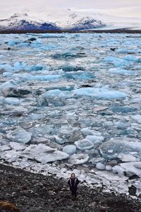 High angle view of woman standing against jokulsarlon lagoon