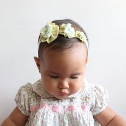 Close-up of cute baby girl over white background