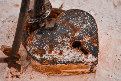 High angle view of rusty metal on wood