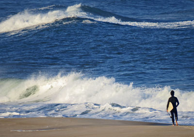 Surfer walking towards ocean