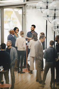 Male and female entrepreneurs talking in office seminar