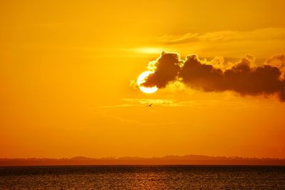 Scenic view of sea against orange sky