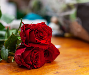 Close-up of red rose on table