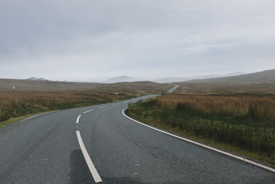 Road by landscape against sky
