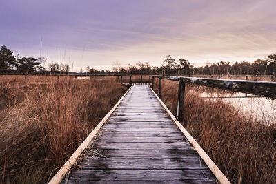 Footbridge over river against sky