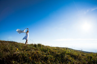 Man standing on field against sky