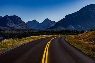 Road amidst mountains against sky