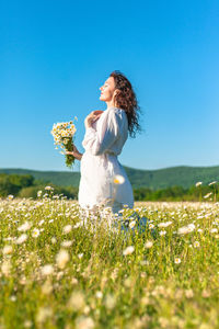 Side view of woman standing on field