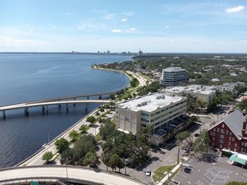 High angle view of townscape by sea against sky