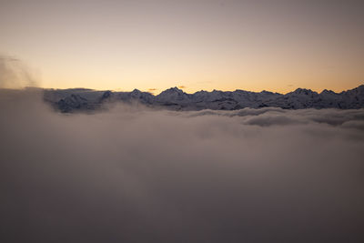 Scenic view of snowcapped mountains against sky during sunset