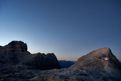 Rock formations against clear blue sky