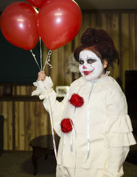 Young woman wearing clown costume