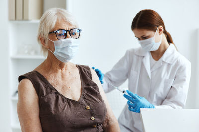 Midsection of women wearing mask