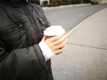 Close-up of woman holding coffee cup