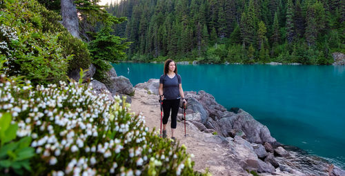 Woman on rock by lake