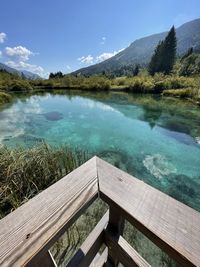 Scenic view of swimming pool by lake against sky