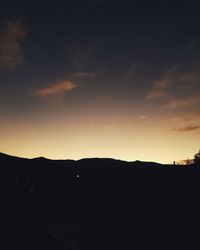 Scenic view of silhouette mountains against sky at sunset