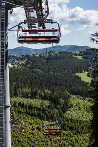 View of ski lift in field against sky