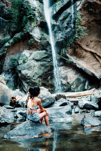 Woman looking at waterfall