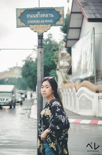 Woman standing on street in city