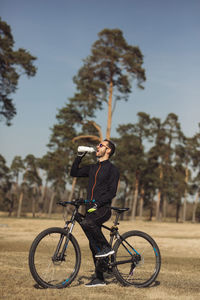 A biker taking rest and drinking water