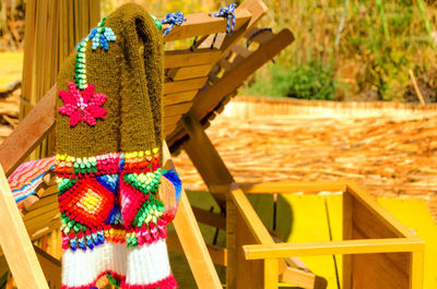 Close-up of multi colored chairs on beach