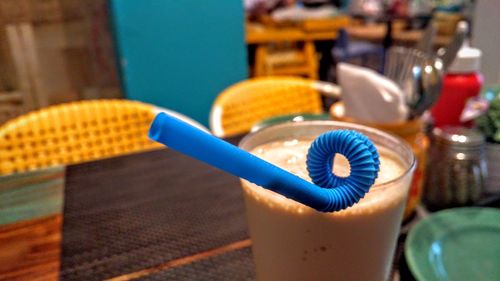 Close-up of blue straw on drink