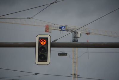 Low angle view of road signal against sky