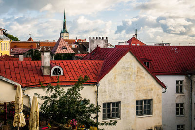 Buildings in town against sky