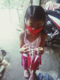 Full length of cute girl sitting outdoors