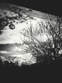 Low angle view of bare trees against sky