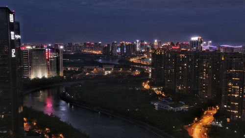 High angle view of illuminated buildings in city at night