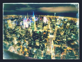 Aerial view of city lit up at night