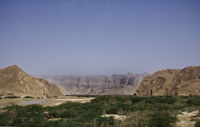 View of rocky mountains against clear blue sky