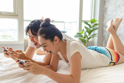 Woman relaxing on bed in bedroom