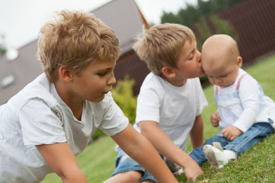 Tilt shot of children playing in grass