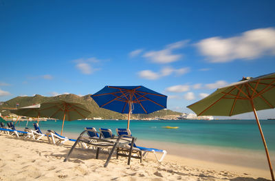 Scenic view of beach against blue sky