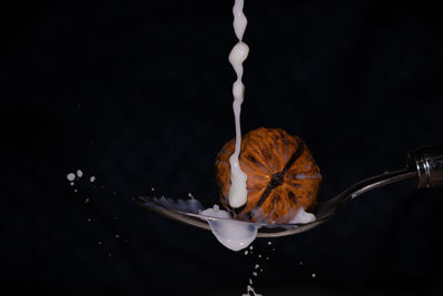 Close-up of drink pouring over black background