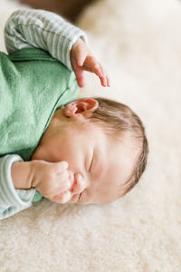 Close-up of baby boy sleeping on bed