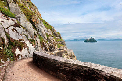 Scenic view of sea and mountains against sky