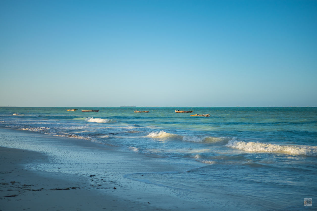 SCENIC VIEW OF BEACH AGAINST CLEAR BLUE SKY