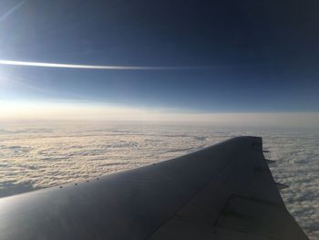 Airplane flying over clouds in sky